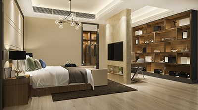 This image shows a modern bedroom with a large bed, stylish lighting, a shelving unit with décor, a mounted TV, and a workspace area.