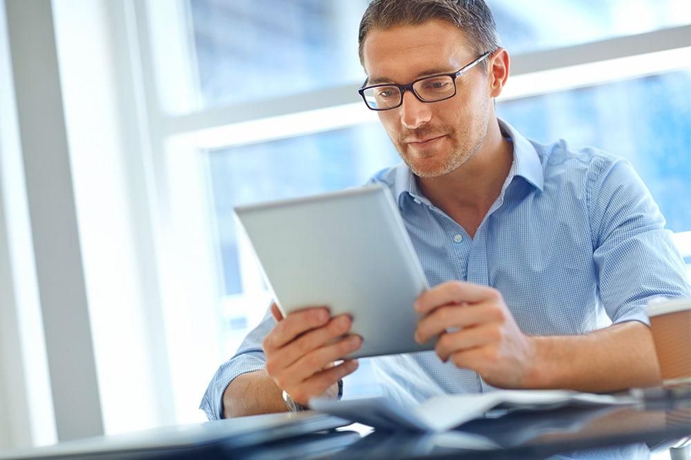 man reviewing data on a tablet at a hotel